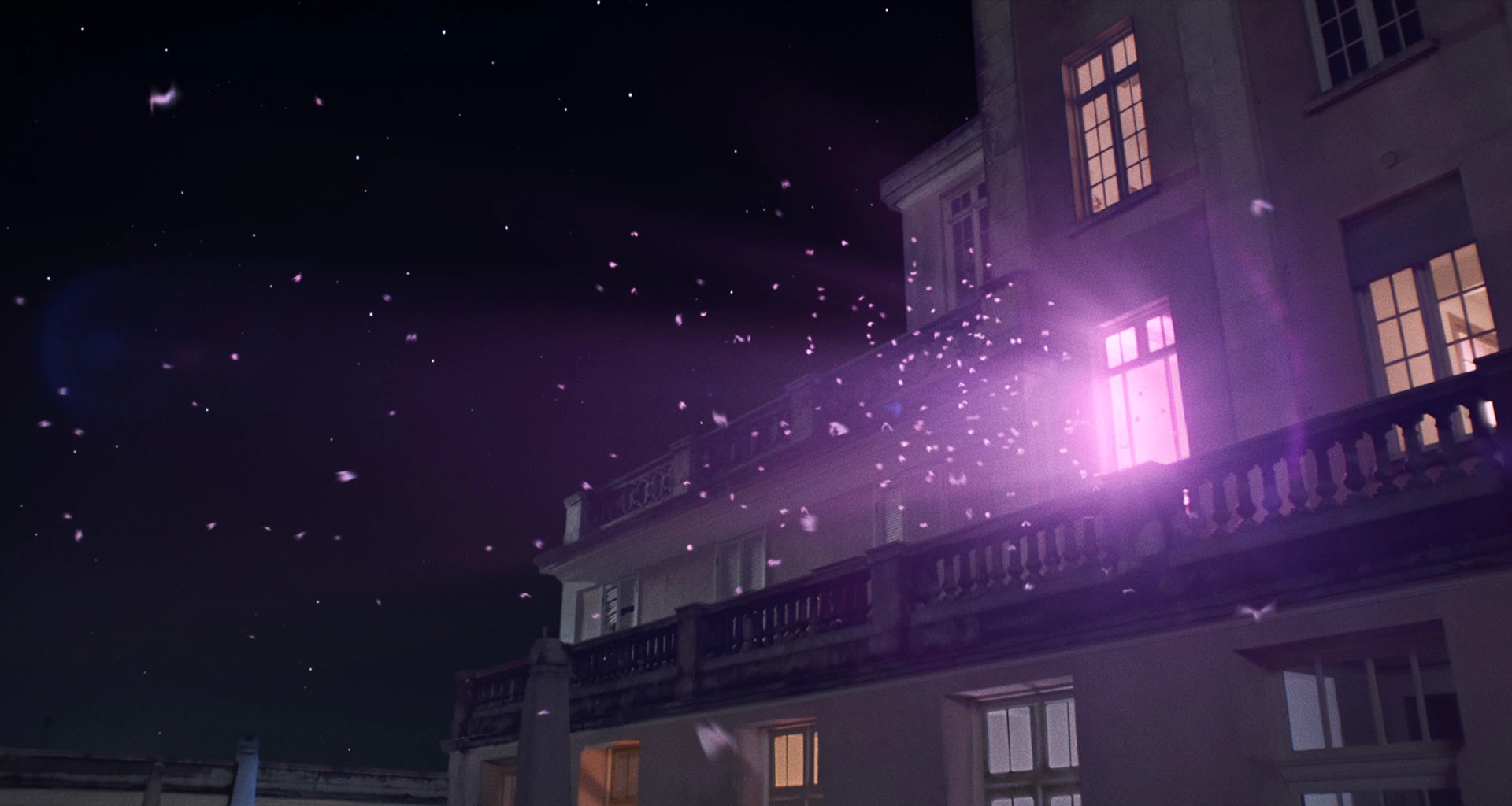 Moths flock across the night sky toward the top of a mansion. From the living room window, the camera cuts to a silhouette of a couple watching TV on the sofa. Bands of blue and purple light sway onscreen.
