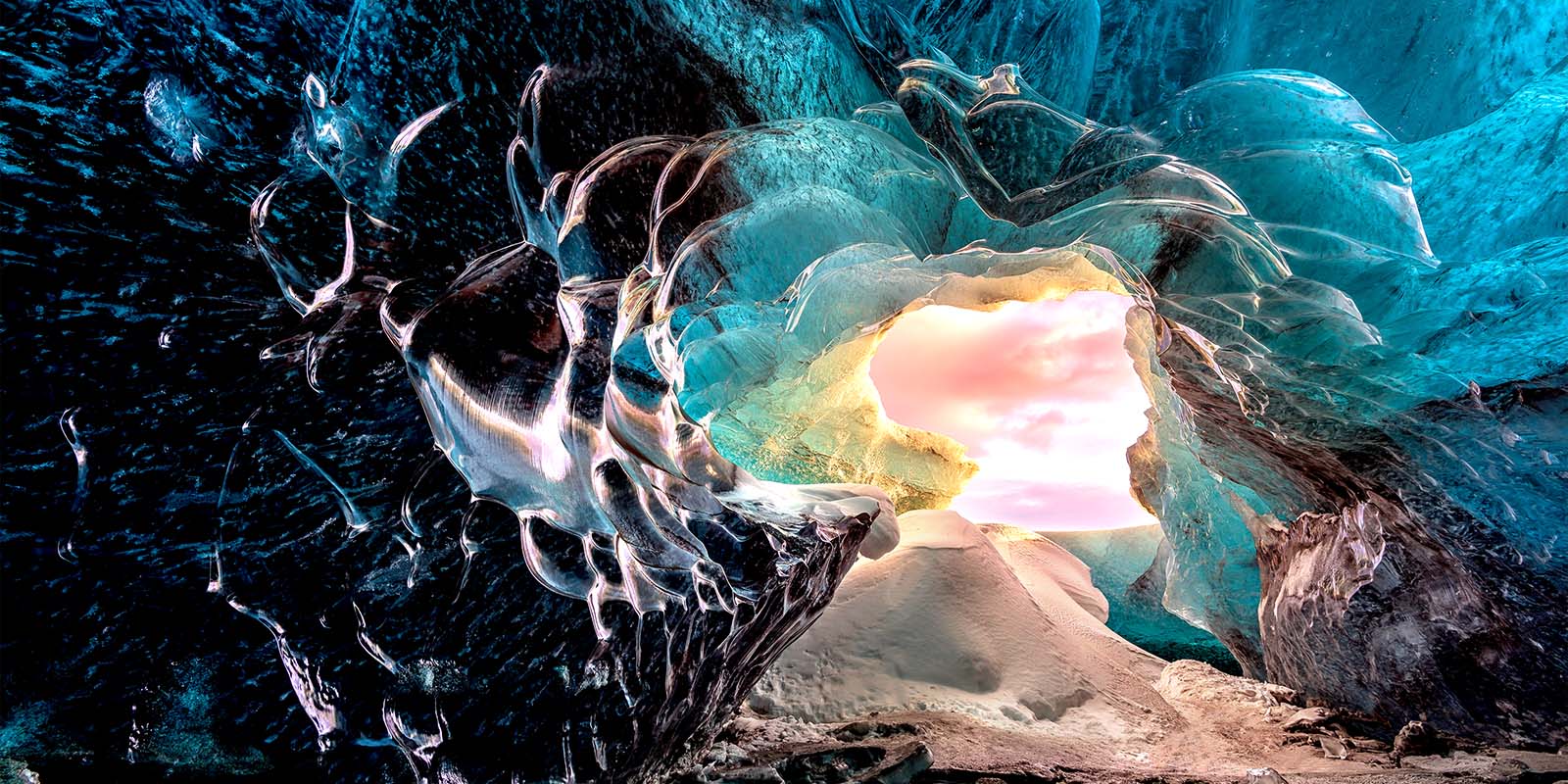 Vue depuis un intérieur d’une grotte, vue vers l’entrée. La grotte est d’apparence surréaliste avec des formations rocheuses et cristallines très détaillées. La scène met en valeur la qualité d’image sans perte visuelle sur les téléviseurs LG True Wireless.