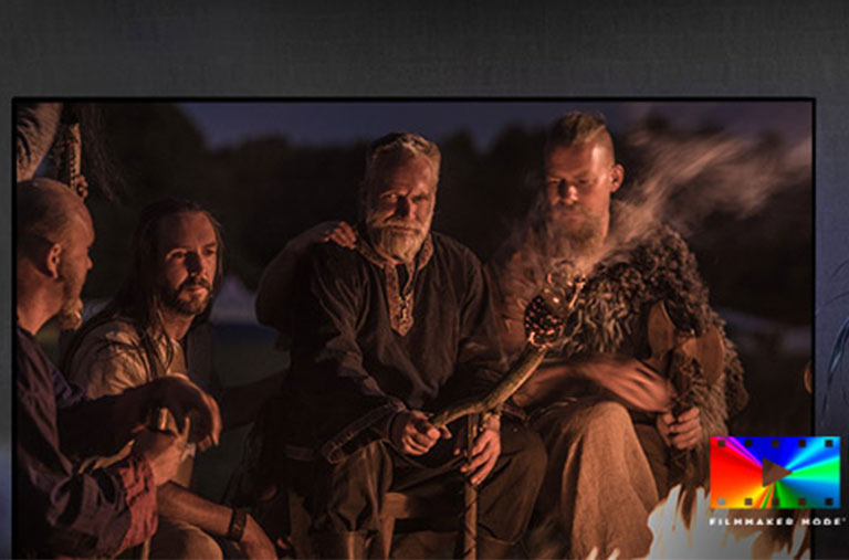 A scene of a fantasy movie on a TV screen and filmmaker mode logo