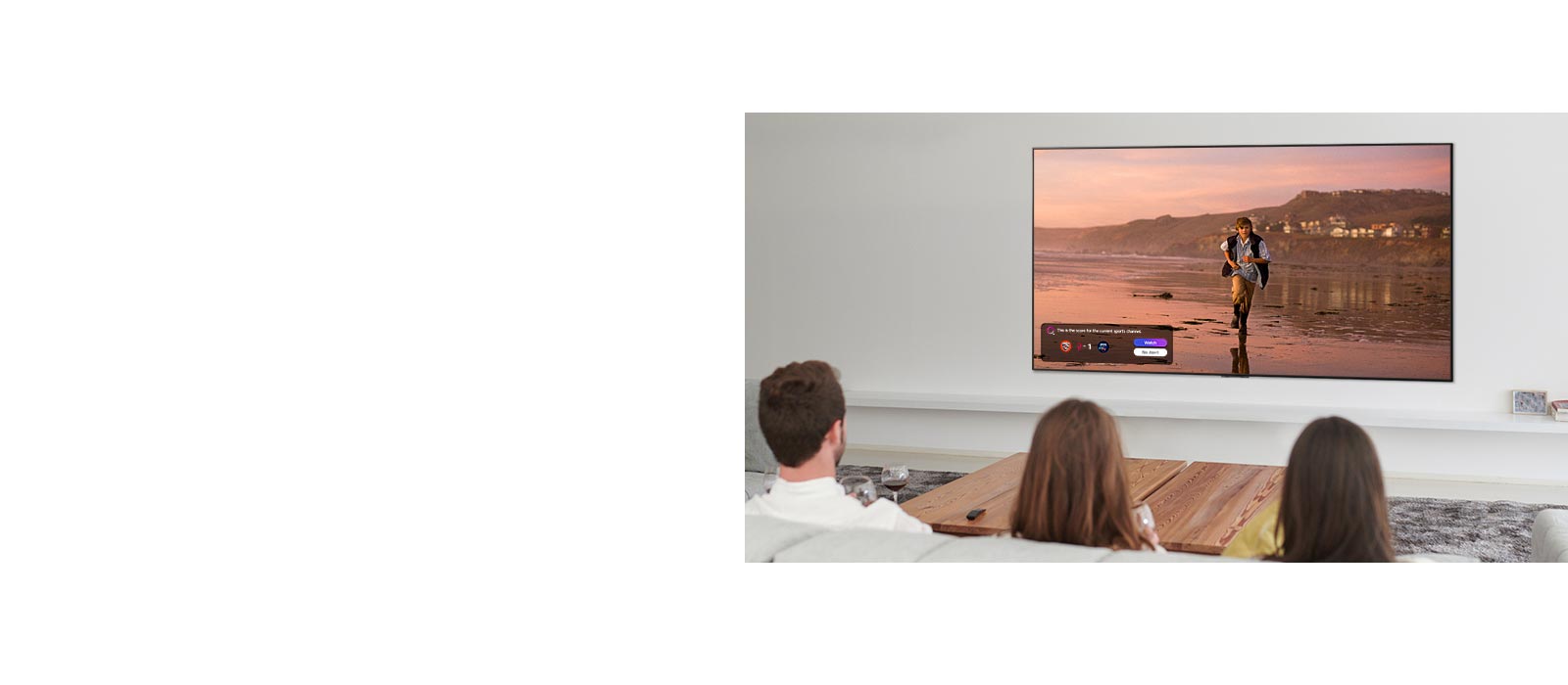 Trois personnes en train de regarder un écran de téléviseur montrant une scène d’un film fantastique avec une Sports Alert