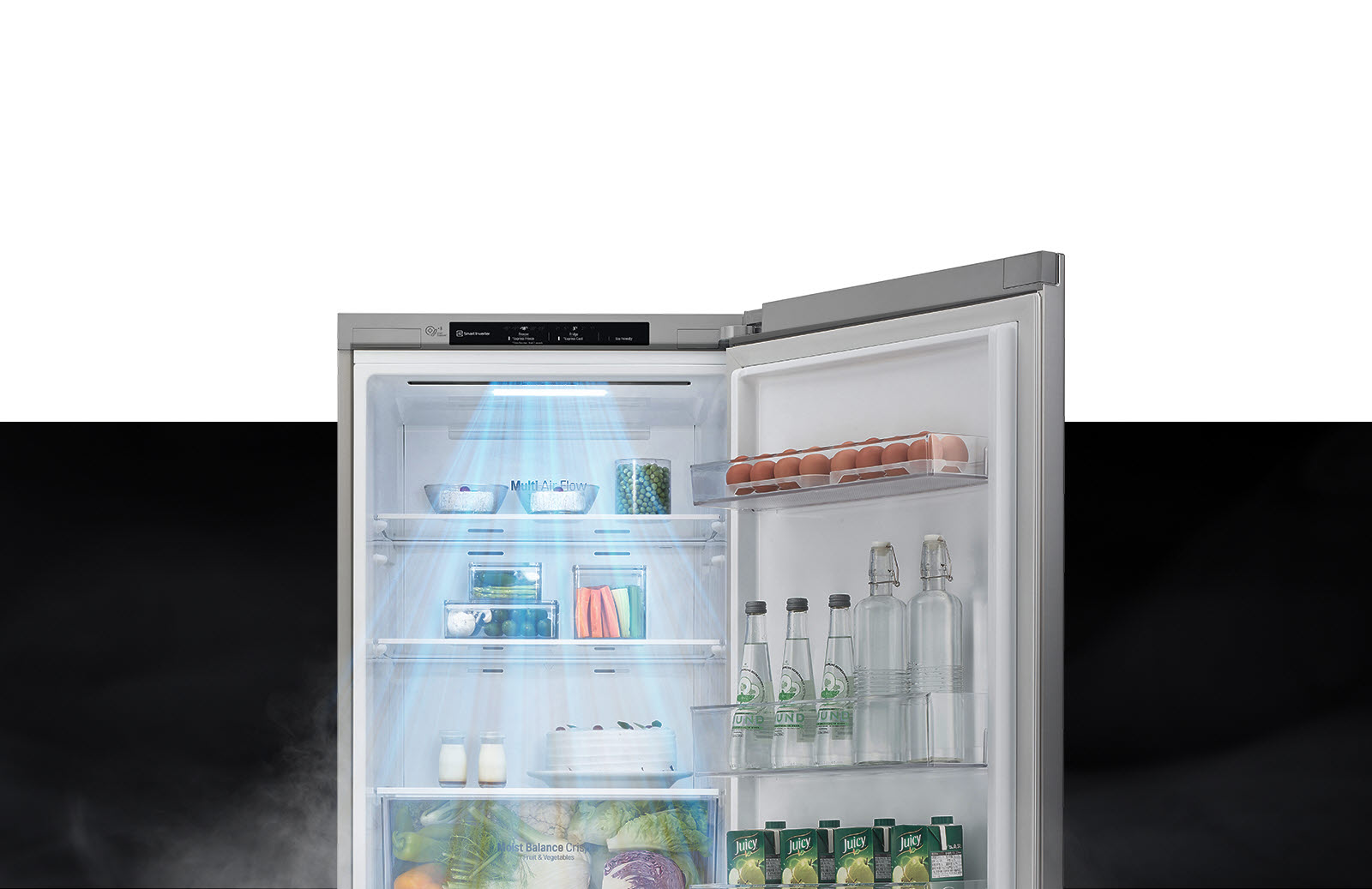 The top half of the refrigerator is shown with the door open. Inside, the shelves are filled with produce and drinks and a gust of wind comes down from the top to cool off the food.