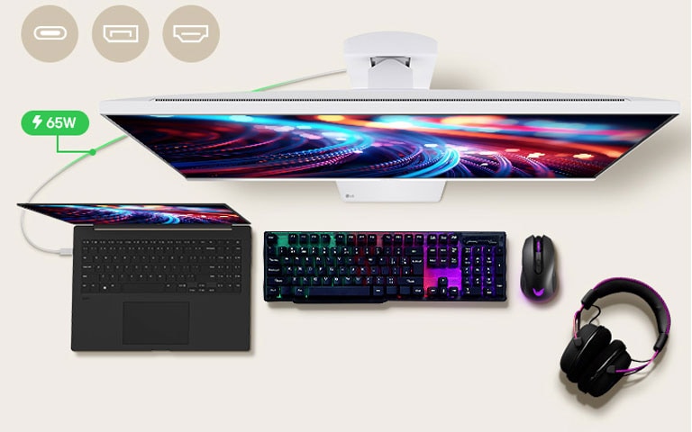 A 32-inch gaming monitor is positioned in the center of the desk, with various IT devices placed around it. 