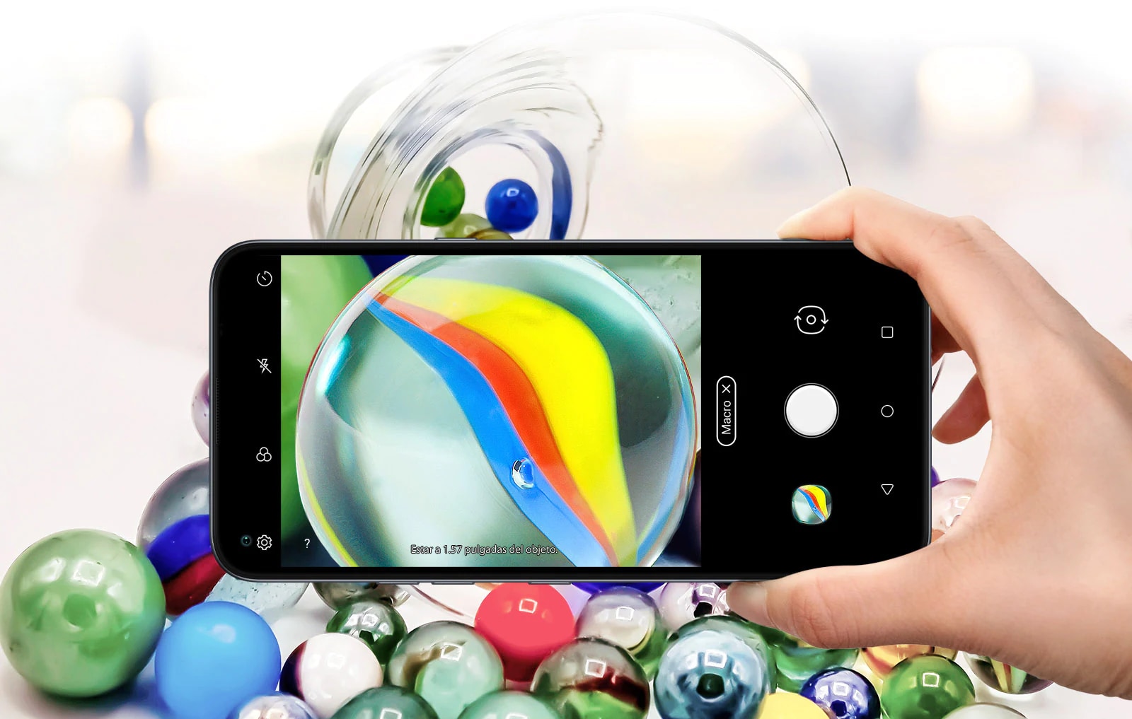 Closeup of someone holding a smartphone taking a picture of some marbles
