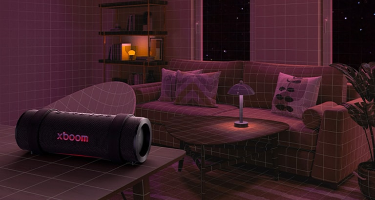 En una habitación con luces rosas, un sofá blanco y una mesa están al fondo. El xboom Grab está sobre una mesa blanca.