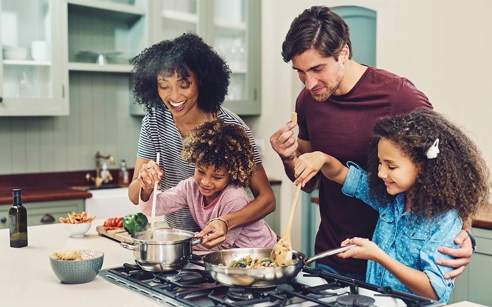 A family cooking together in the kitchen