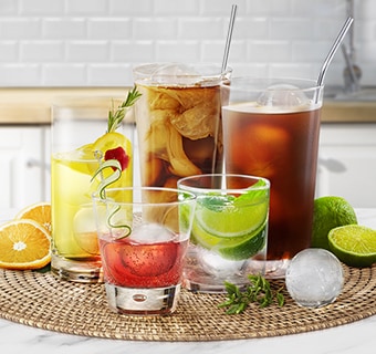 Collection of colourful beverages on countertop with Craft Ice balls