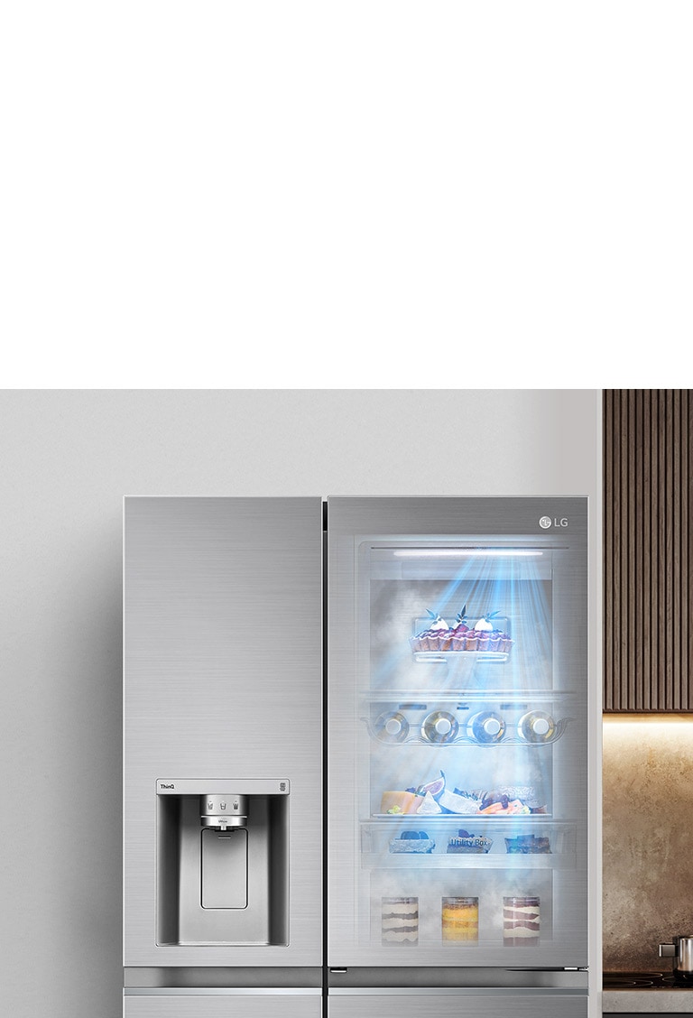 The front view of a black InstaView refrigerator with the light on inside. The contents of the refrigerator can be seen through the InstaView door. Blue rays of light shine down over the contents from the DoorCooling function. 