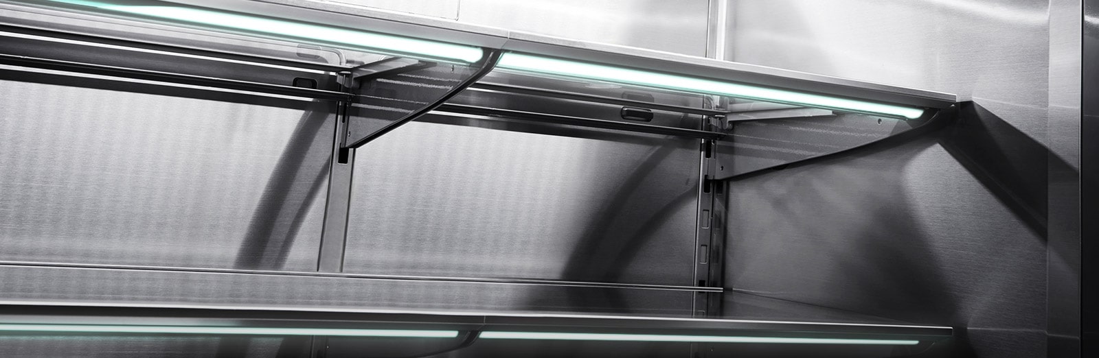 Close horizontal shot of the stainless inner walls of LG SIGNATURE Refrigerator.