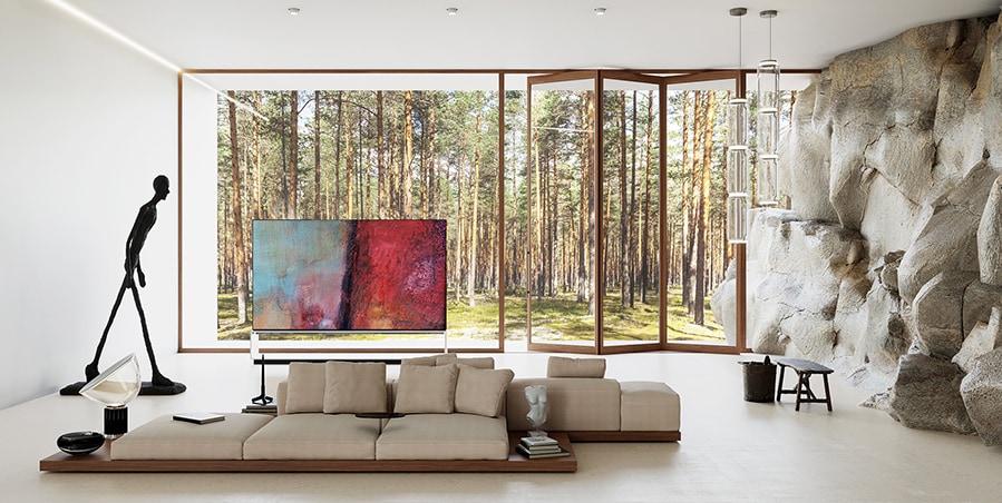 LG SIGNATURE OLED 8K TV is placed on the natural living room in harmony with B&B Italia’s dock sofa system.