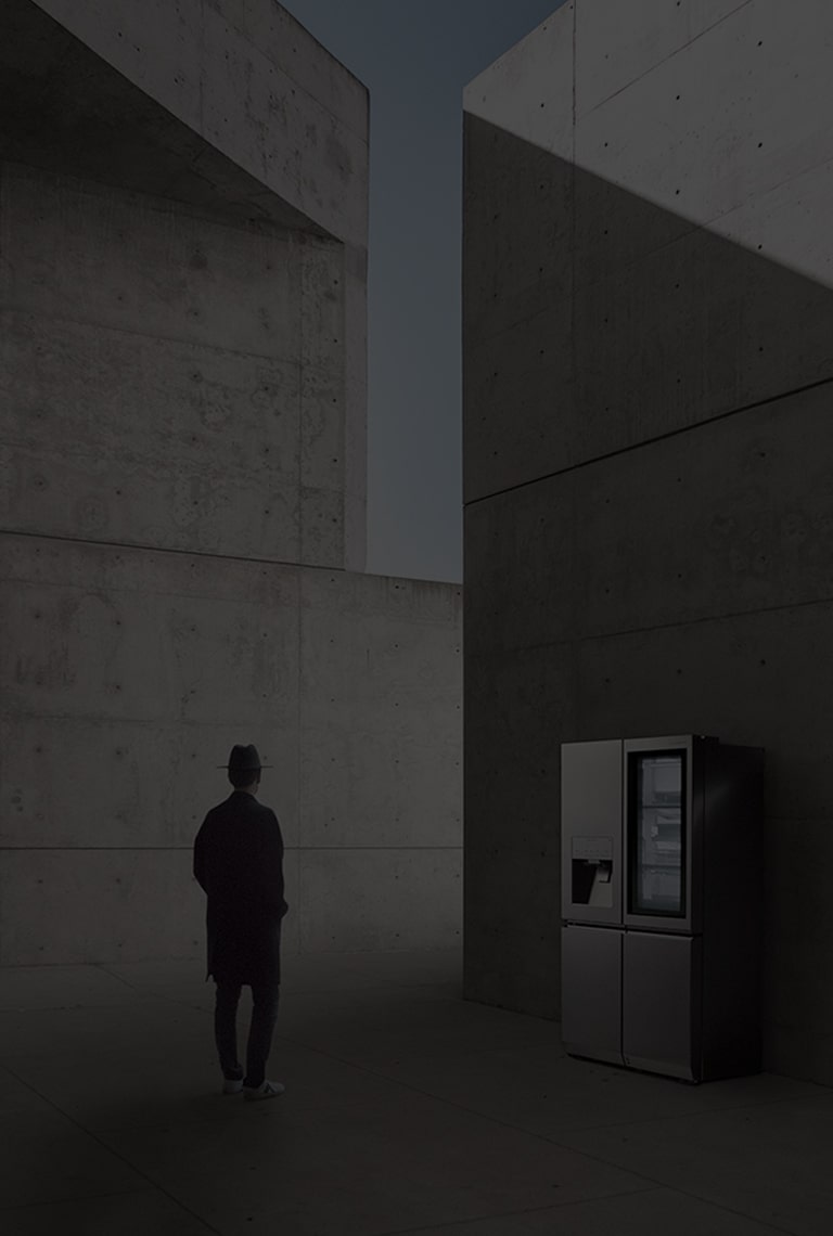 creator and photographer of minh tran is standing in front of lg signature refrigerator and staring it in the overally unique architectural site