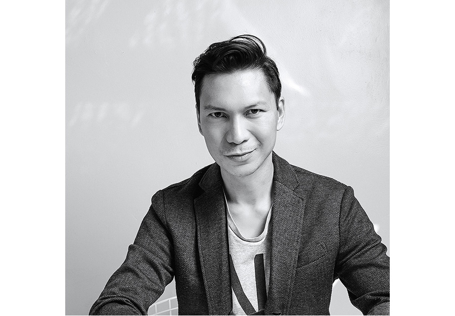 a black and white profile image of creator minh tran who is smiling