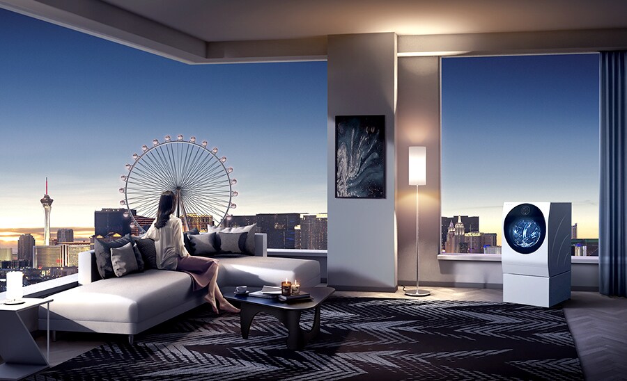 A woman looks out the window to see Las Vegas' High Roller from her living room, where LG SIGNATURE's Washing Machine is placed in the corner of the room.