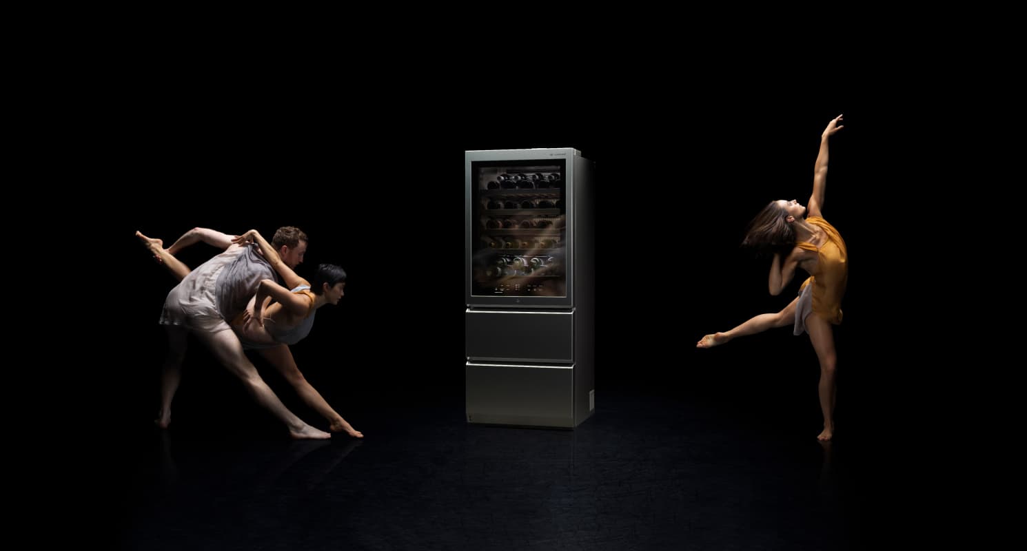 Ballet dancers performing around an LG SIGNATURE Wine Cellar against a black backdrop.