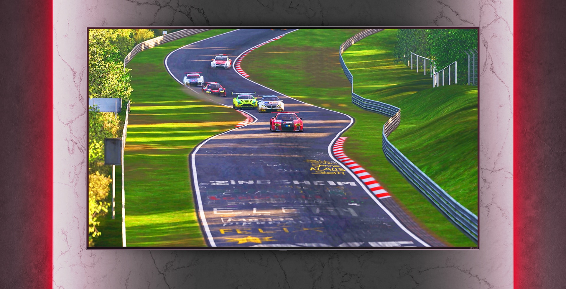 Wall mounted NanoCell TV. The racing game is played. Below that, the improved image quality is seen through Nanocell technology.
