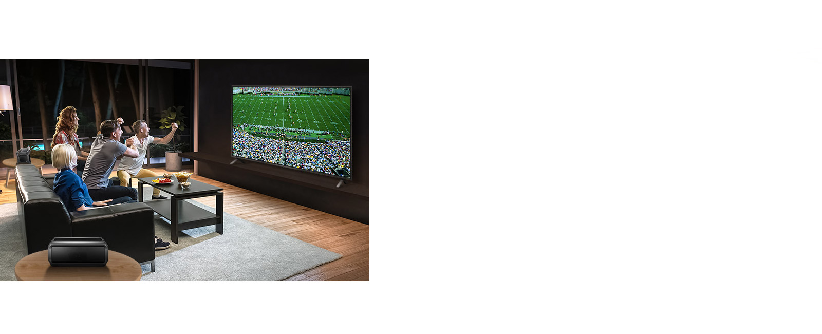 People watching sports game on TV in the living room with Bluetooth rear speakers.