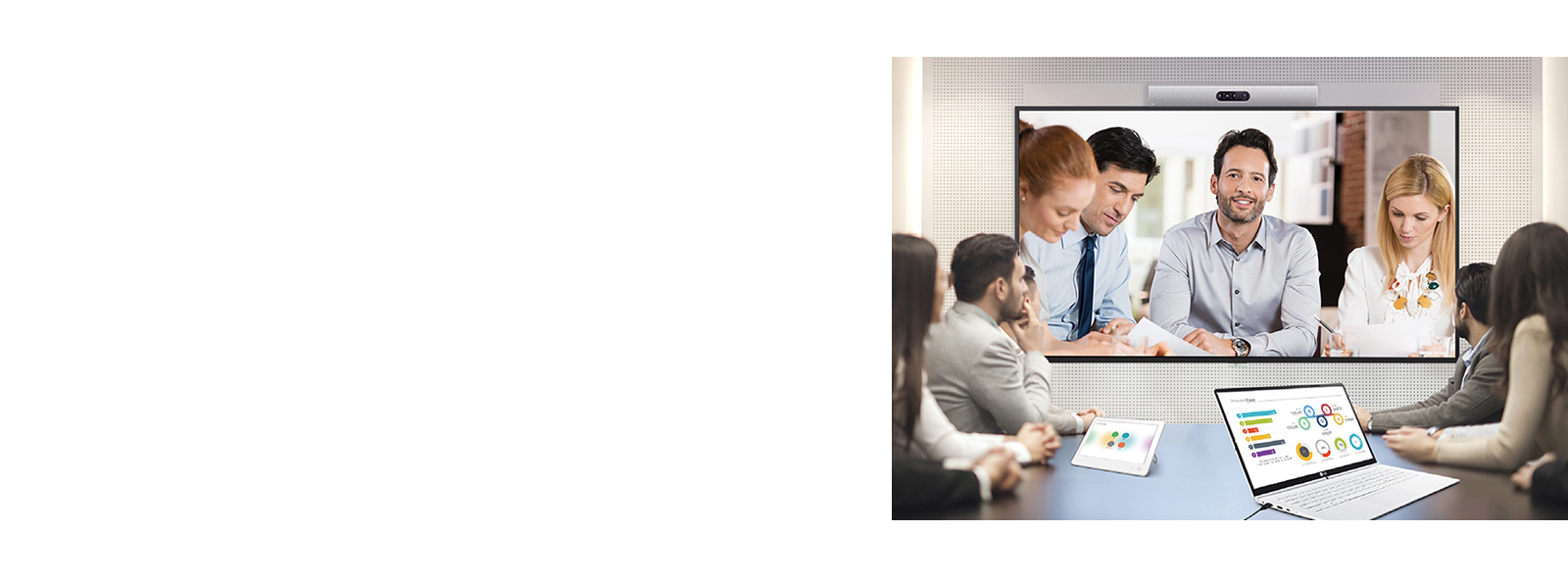 A video conference is being held as people are  screened on signage installed on the wall. 