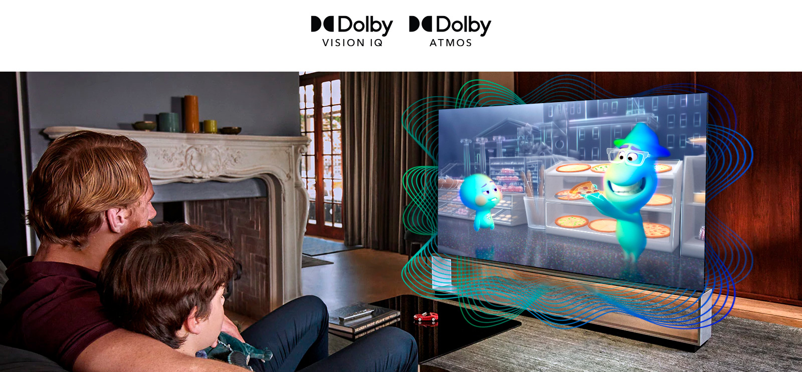 The logo of Dolby Vision IQ and Atmos are in line horizontally. Under the logos, a father and a son sitting on a couch are watching television displaying  a girl  holding a mineral in the middle of black and orange background.