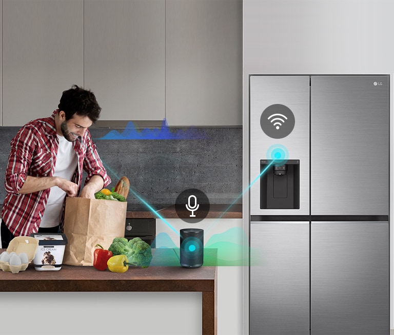 A man stands in a kitchen unloading produce from a grocery bag and speaks, shown by volume bars moving up and down near him, to the AI speaker on the counter telling it to "turn on express freeze". A line appears that goes from the man to the AI speaker which has a microphone icon above it. Then volume bars show up near the AI speaker and a line appears from the AI speaker to the refrigerator which has a Wifi icon above it.