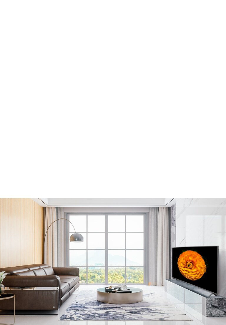 LG UHD TV, located on the wall in a living room with the minimal interior. Image of a flower is shown on the TV screen.