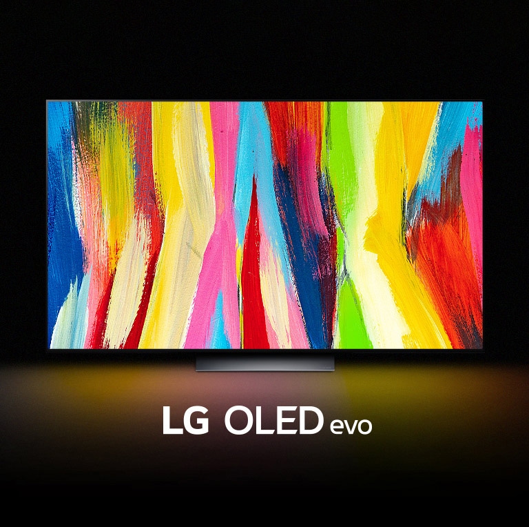An LG OLED C2 is in a dark room with a colorful abstract artwork of vertical lines on its display and the words "LG OLED evo" underneath.