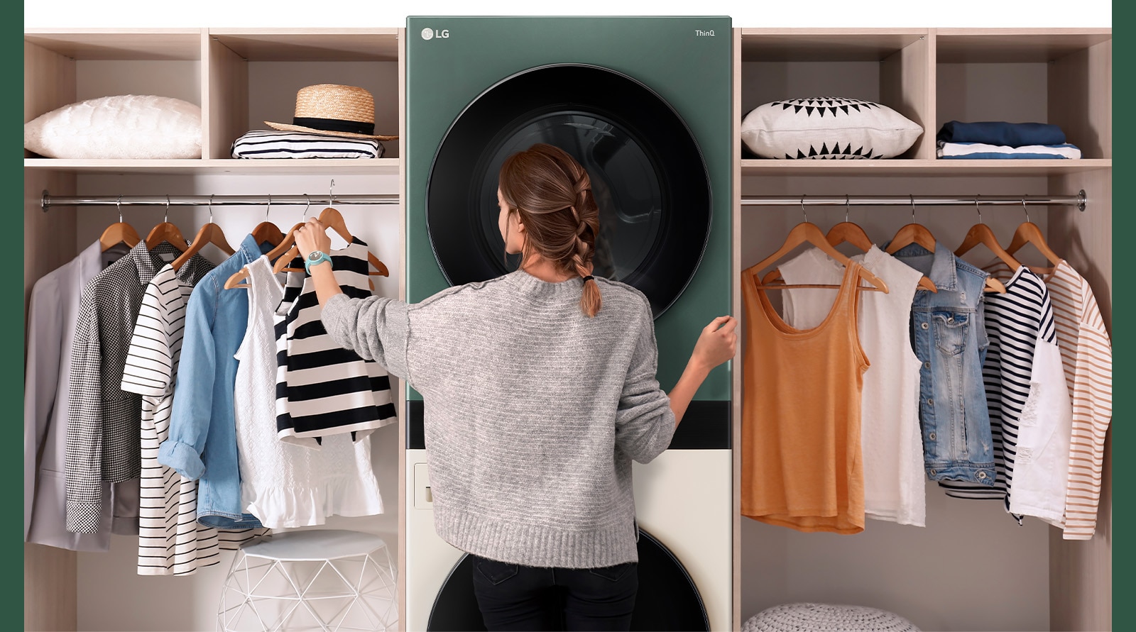 A WashTower is installed between the hangers, and a woman is choosing clothes in front.