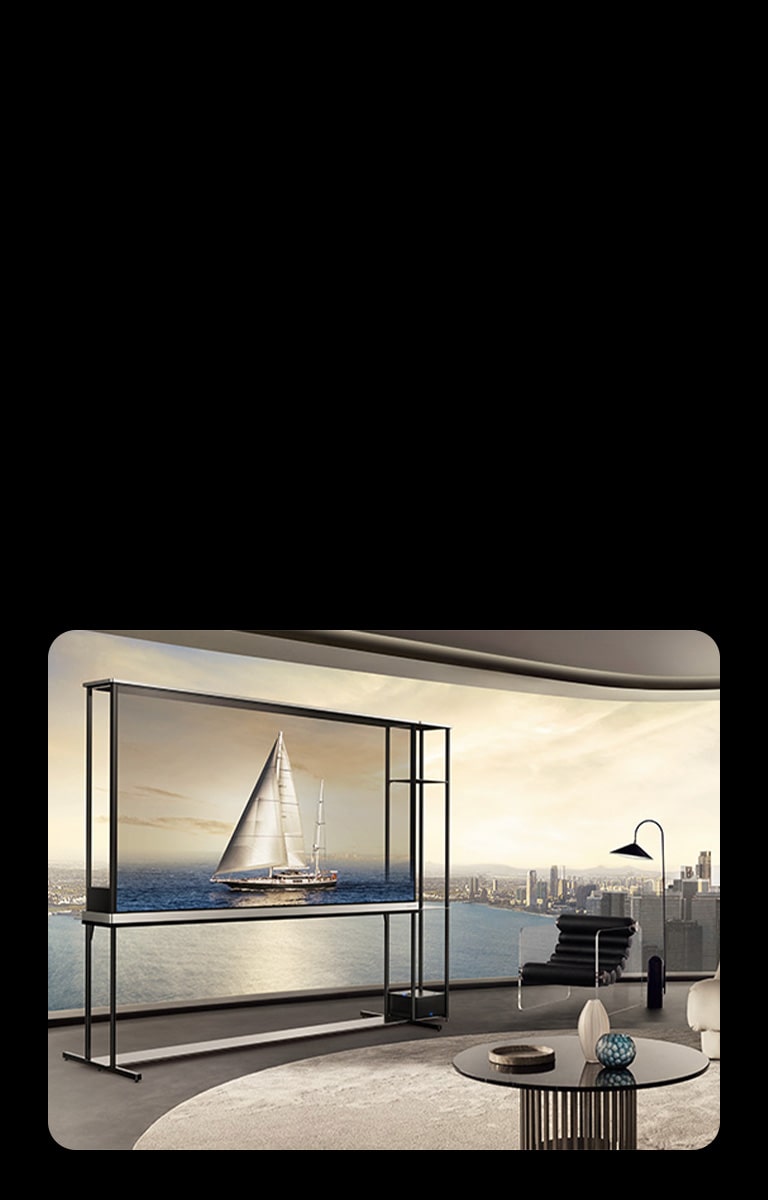 LG OLED T4 dans un appartement penthouse. Les fenêtres donnent sur la ville et l’océan. La LG OLED T4 est en mode transparent et affiche une image d’un yacht. En raison de la position du téléviseur et de la transparence de l’écran, le yacht semble flotter sur l’océan extérieur.