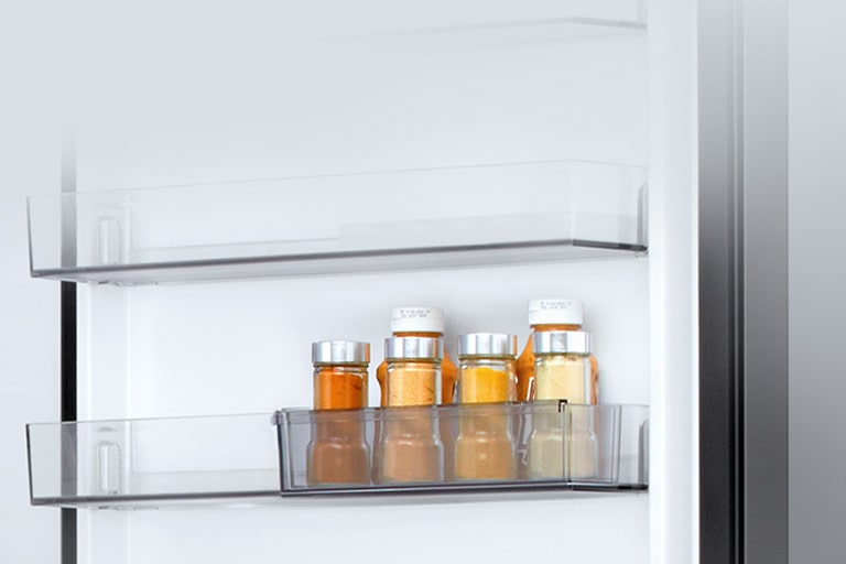 LG bottom freezer (GBBW726AEV) interior with transparent sliding mini door basket holding six small sauce bottles