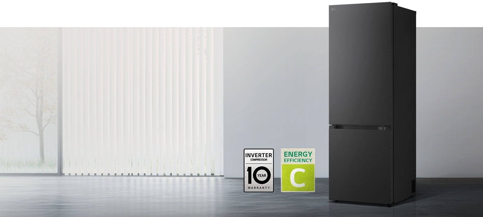 Réfrigérateur LG à congélateur en bas (GBBS726CEV) noir mat, vue de face dans une pièce lumineuse avec stores verticaux, compresseur garanti 10 ans et label d'efficacité énergétique A ci-dessous.