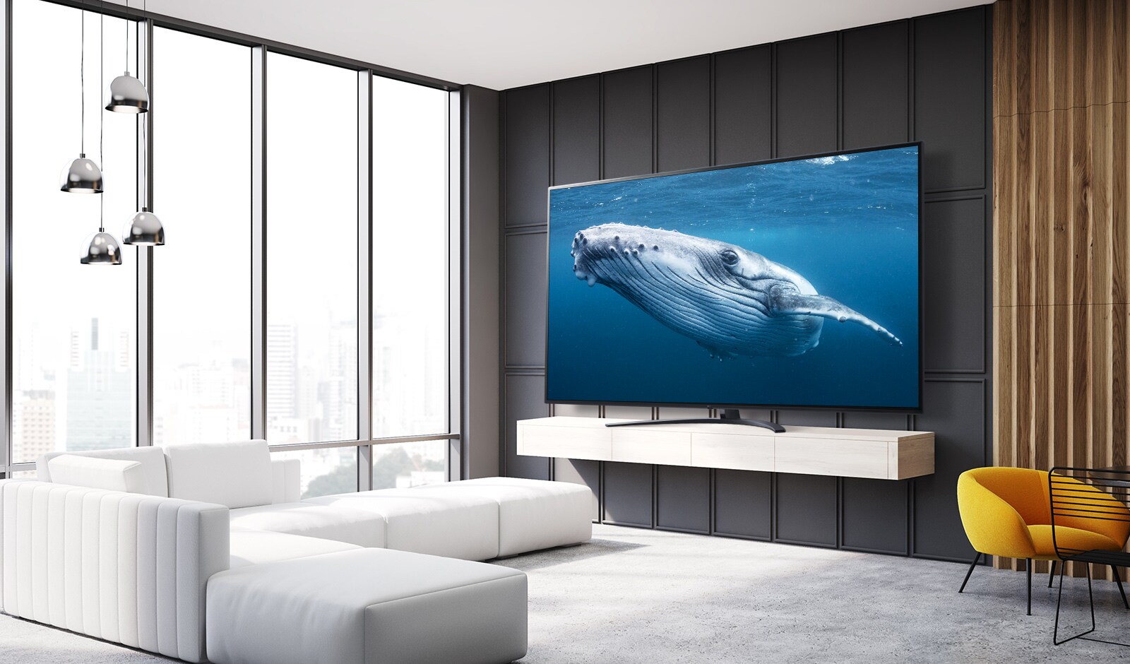 Dans un salon, il y a un grand écran de téléviseur qui affiche l’image d’une baleine dans la mer.