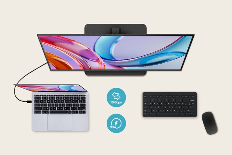 Vue supérieure d’un moniteur connecté à un ordinateur portable avec un clavier et une souris en-dessous.