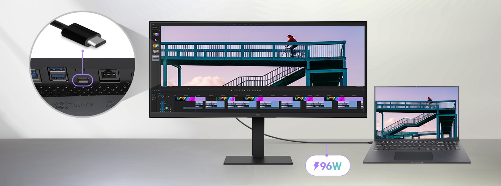 Moniteur UltraWide connecté à un ordinateur portable via un câble USB-C, affichant un projet d’édition vidéo avec un cycliste sur un pont et un gros plan du port USB-C, mettant en évidence la capacité de transmission d’énergie de 96 W.