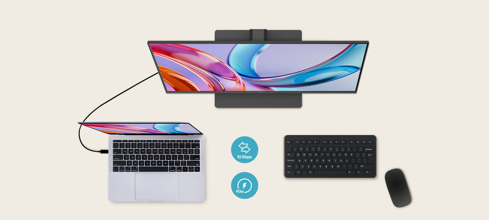 Vue du dessus d’un moniteur connecté à un ordinateur portable, avec un clavier et une souris placés en dessous.