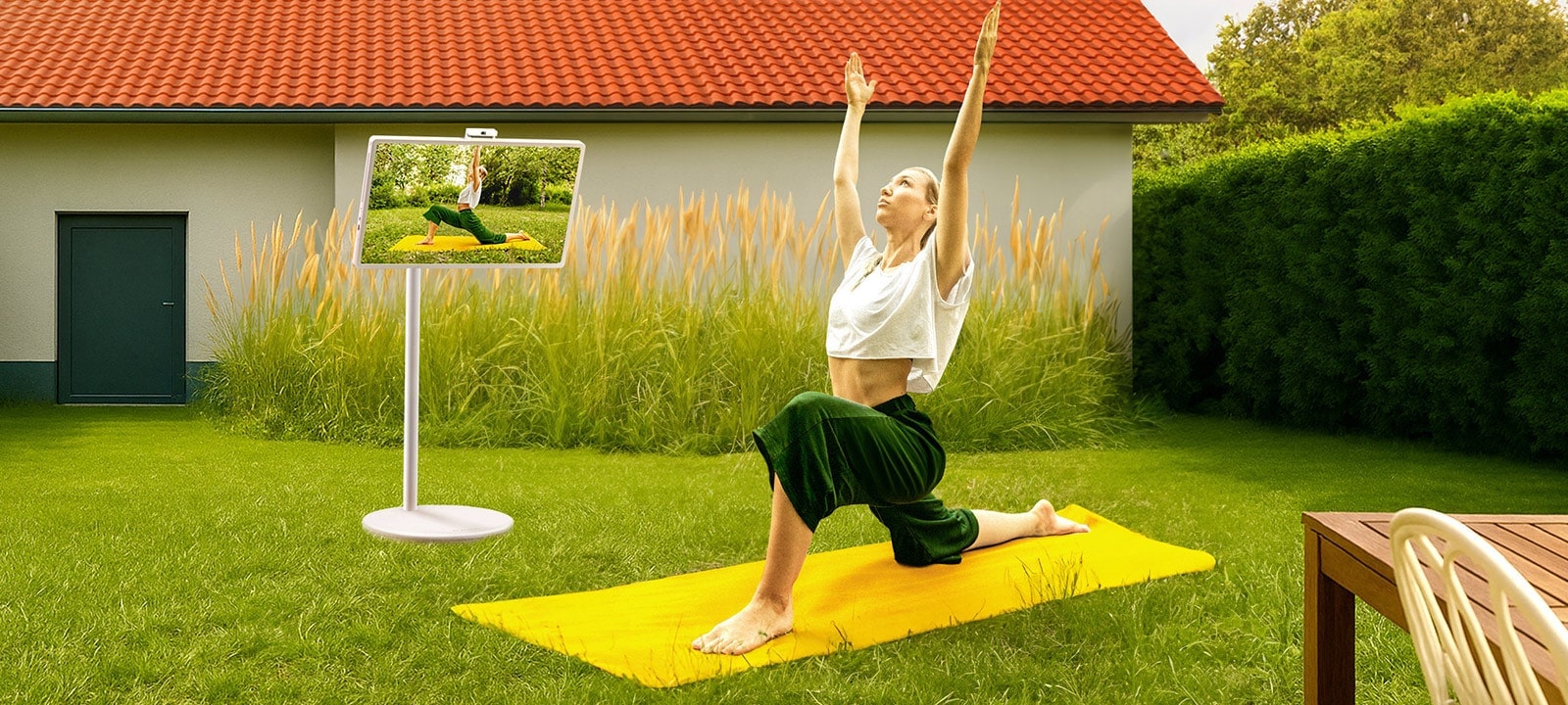 A woman in a yoga pose reflected on the screen of StanbyME 2.