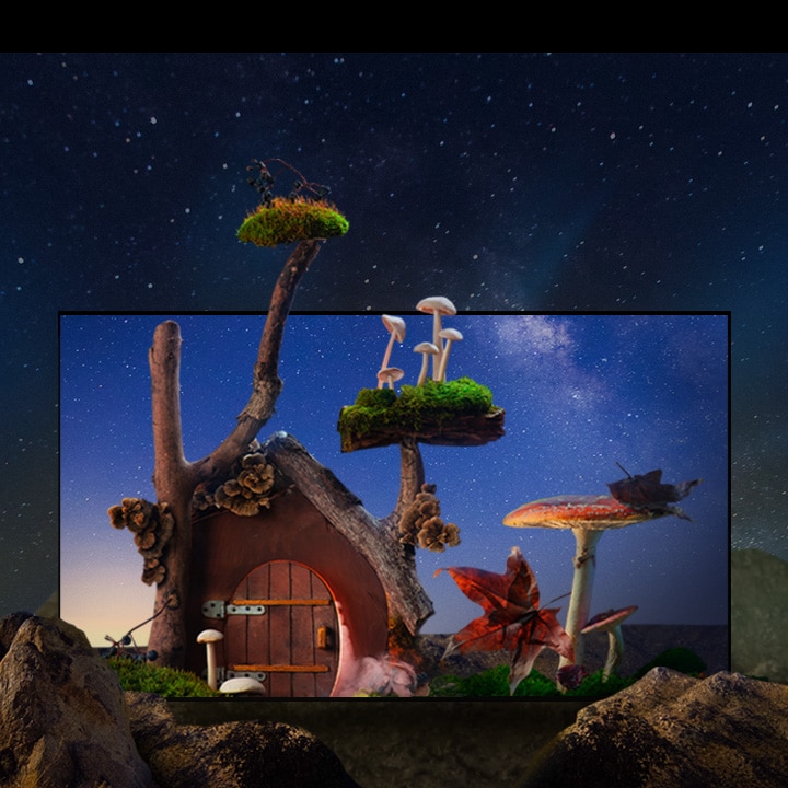 Une petite maison fantastique avec des arbres, des champignons et de gros rochers se trouve sous un ciel étoilé