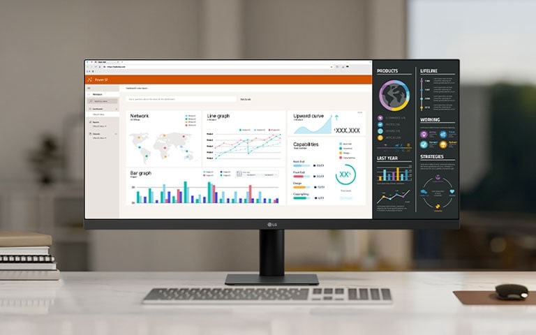 Изключително широк монитор LG на бюро в офис, показващ множество табла с данни и графики за продуктивност и многозадачност.
