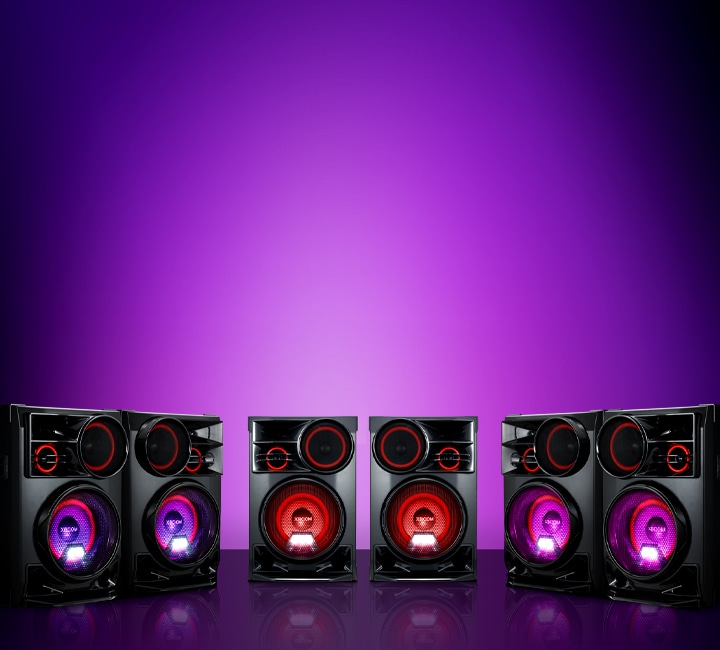 La imagen muestra un fondo degradado de color púrpura. Tres pares de altavoces LG XBOOM CL98 se encuentran sobre el fondo en formato de arco.