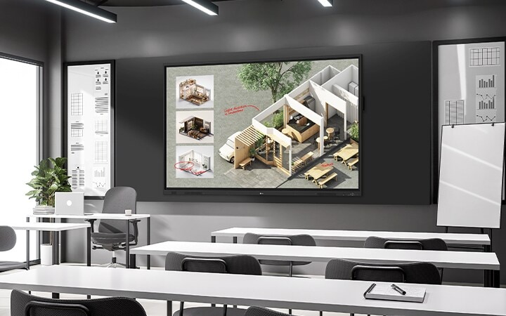 En el aula, hay una gran pizarra digital interactiva instalada en la pared que muestra vívidamente los materiales de la clase.