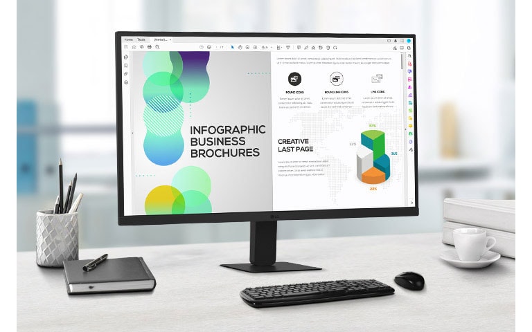 On the desk, there is a QHD IPS monitor displaying document work. Next to the monitor, there is a pencil holder, a diary, a pen, a keyboard, a mouse, and a cup.	