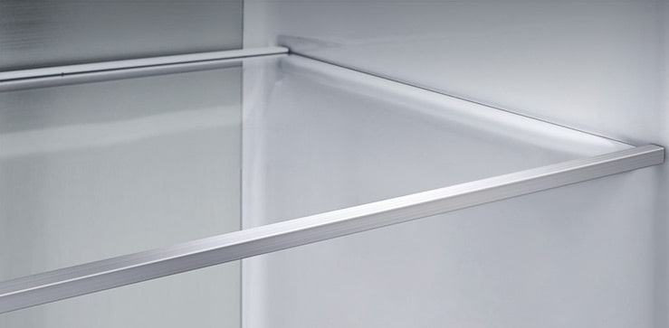 Diagonal view of the shelf with metal panels inside the refrigerator.
