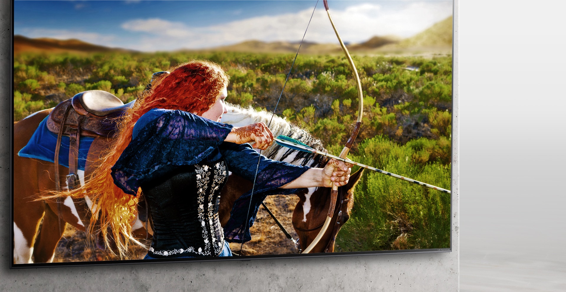 A Nanocell TV is hanging on a wall. On the screen, a medieval archer aims her bow.