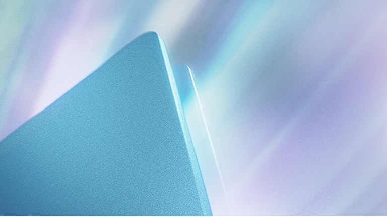 这张图片展示了笔记本电脑金属边框的特写，并泛有柔和的渐变光反射。