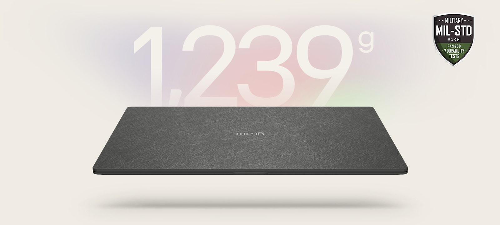 An animation showcasing a lightweight laptop with '1,239g' displayed in the first frame and '12.4mm' thickness in the second frame. Both frames include the MIL-STD durability badge, emphasizing portability and durability.