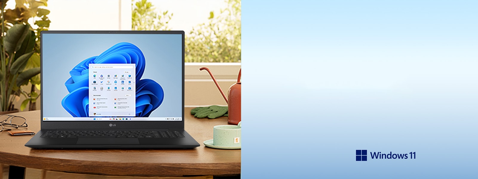 这张图片中，一台笔记本电脑放置于木桌之上，屏幕正显示 Windows 11 系统，电脑周围摆放着绿植和台灯，营造出宁静的办公氛围。