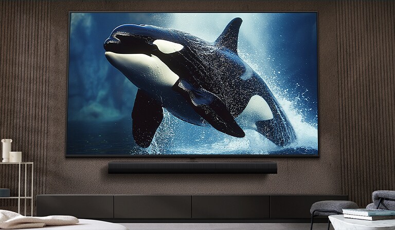 在现代风格的客厅里，超大屏幕的 LG TV 安装在墙上，位于 LG Soundbar 上方。