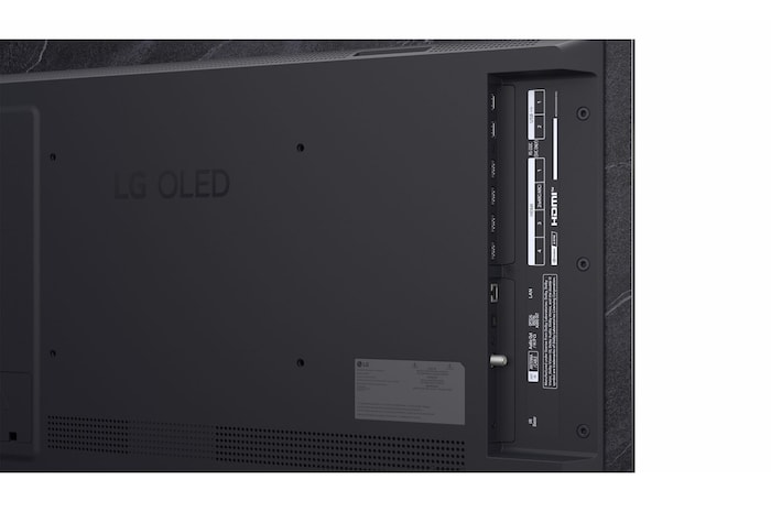 The front view of LG OLED evo AI C6, released in 2026, features a slim black bezel, with a vivid, sculpted swirl of layered rainbow tones flowing across the screen.