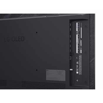 The front view of LG OLED evo AI C6, released in 2026, features a slim black bezel, with a vivid, sculpted swirl of layered rainbow tones flowing across the screen.