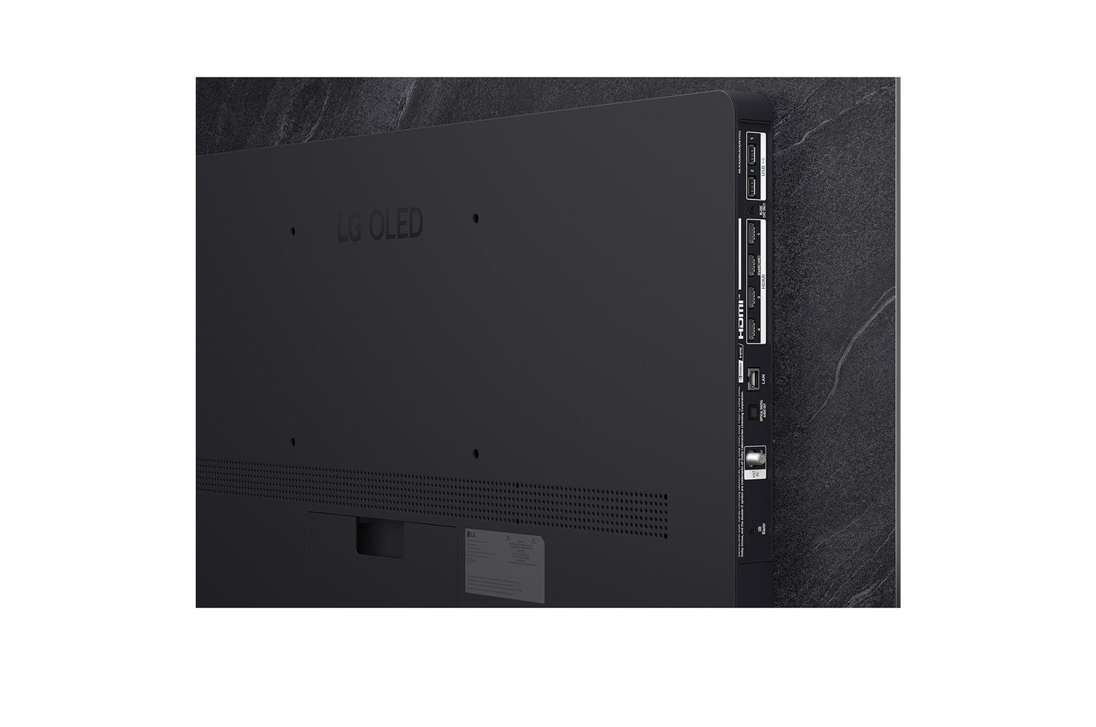 The front view of LG OLED evo AI C6, released in 2026, features a slim black bezel, with a vivid, sculpted swirl of layered rainbow tones flowing across the screen.