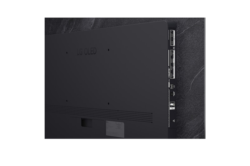 The front view of LG OLED evo AI C6, released in 2026, features a slim black bezel, with a vivid, sculpted swirl of layered rainbow tones flowing across the screen.