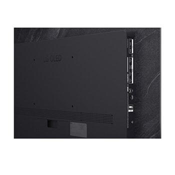 The front view of LG OLED evo AI C6, released in 2026, features a slim black bezel, with a vivid, sculpted swirl of layered rainbow tones flowing across the screen.