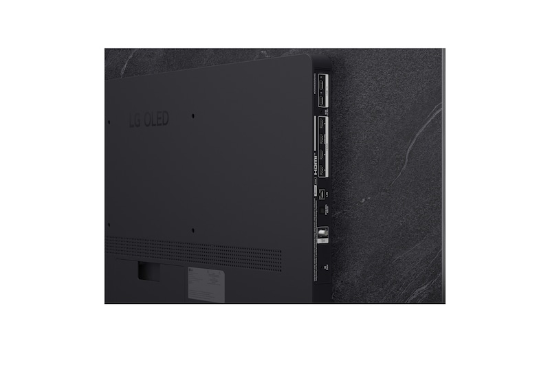 The front view of LG OLED evo AI C6, released in 2026, features a slim black bezel, with a vivid, sculpted swirl of layered rainbow tones flowing across the screen.